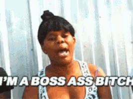 a woman says i 'm a boss ass bitch in front of a white wall