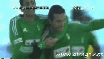 a man in a green adidas jersey is being held up by another man
