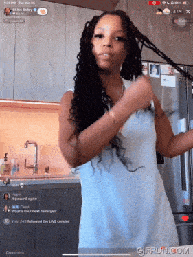 a woman in a white dress is standing in front of a refrigerator with a gifrun.com watermark