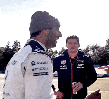 two men are standing next to each other and one is wearing a jacket that says rapid epicor on it