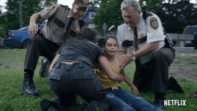 a girl is being helped by a group of police officers with a netflix logo in the background
