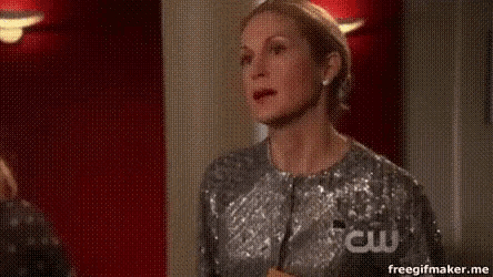 a woman in a sequined dress is standing in front of a red wall and a sign that says special sneak peek .