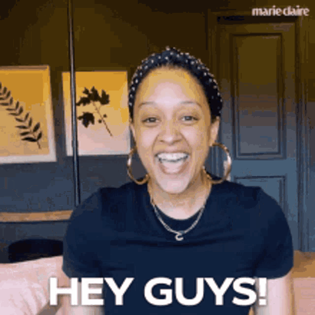a woman in a black shirt says hey guys