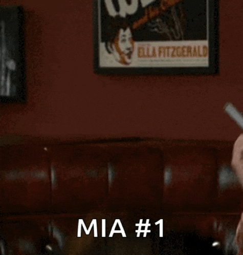 a man is holding a binder in his hand and says mia # 1