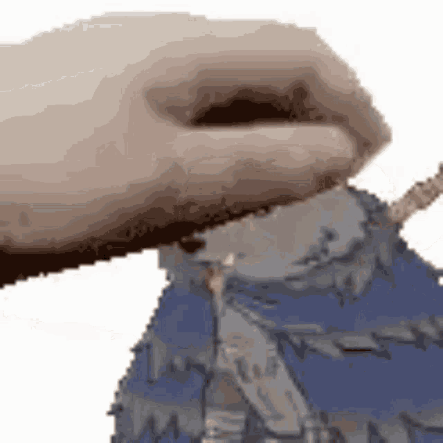 a close up of a person 's hand holding a cartoon character on a white background .