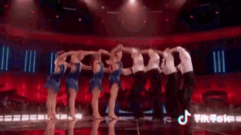 a group of people are dancing on a stage .