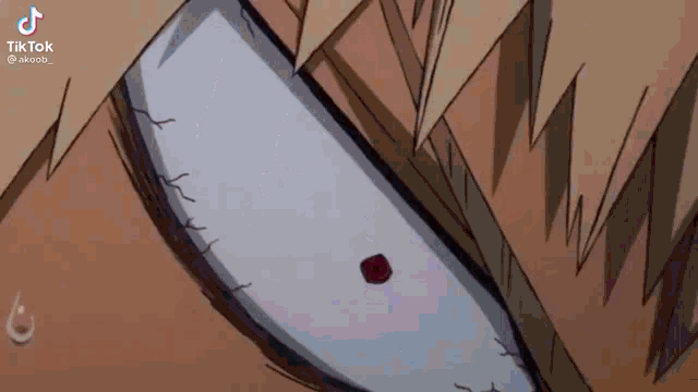 a close up of a cartoon character 's eye with a red spot on it .
