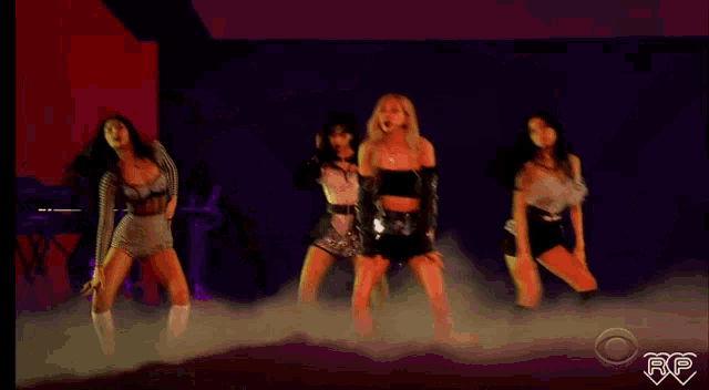 a blurry photo of three women dancing with the letters rp on the bottom