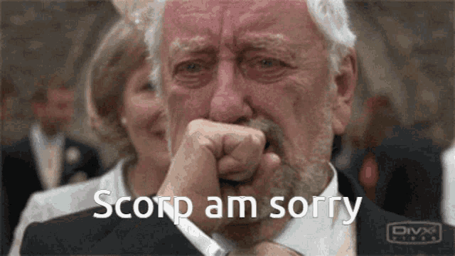 a man in a suit and tie is crying with the words " scorp am sorry " above him