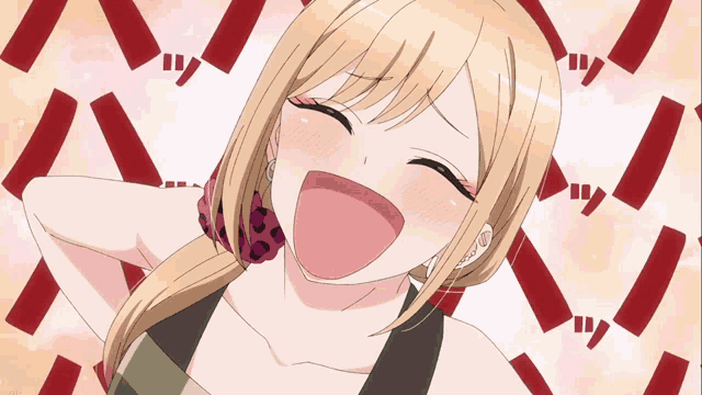 a girl with blonde hair is laughing with red letters behind her
