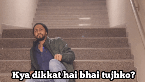 a man sits on a set of stairs with the words kya dikat hai bhai tujhko