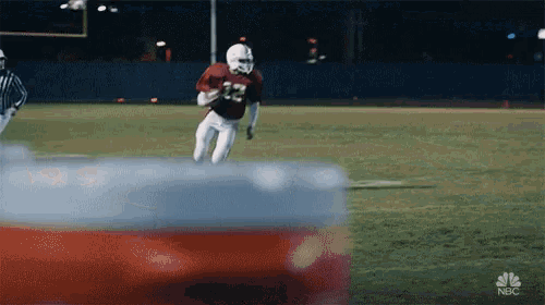 a football player with the number 32 on his jersey is running on a field