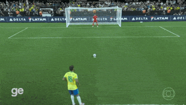a soccer game is being played on a field with delta latam advertisements