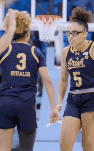 a female basketball player wearing a jersey that says irish