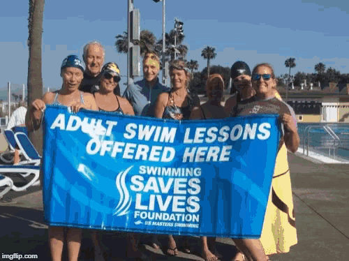 a group of people are holding a sign that says adult swim lessons offered here
