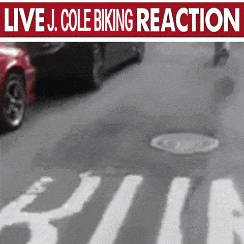 a live j. cole biking reaction advertisement with a car driving by