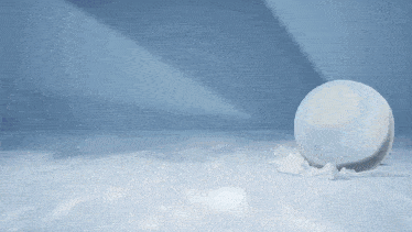 a snowball is being thrown in the air by a person wearing a goggles