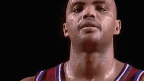 a close up of a basketball player 's face with sweat coming out of his neck .