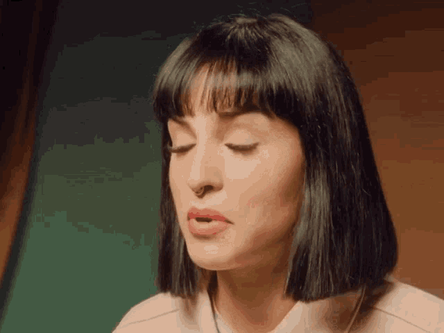 a close up of a woman 's face with her eyes closed and red lips