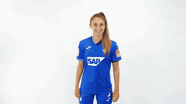 a woman wearing a blue shirt that says sap