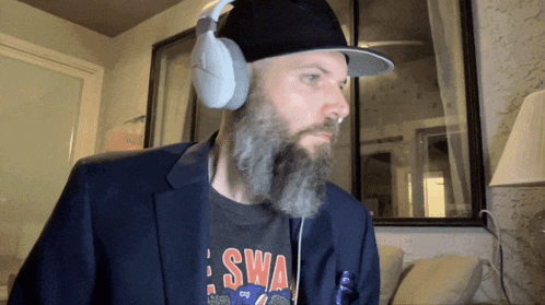 a man with a beard wearing headphones and a t-shirt that says swa