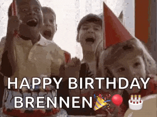 a group of children are sitting around a birthday cake .