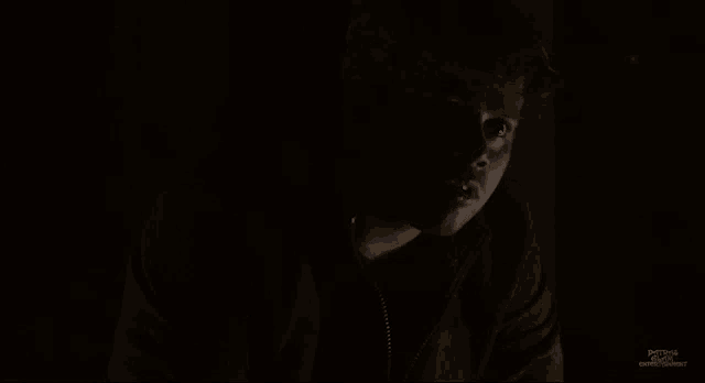 a man in a dark room with the words patrick o'brien written on the bottom