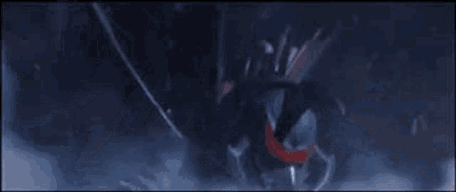 a close up of a monster in a dark room with a red eye .