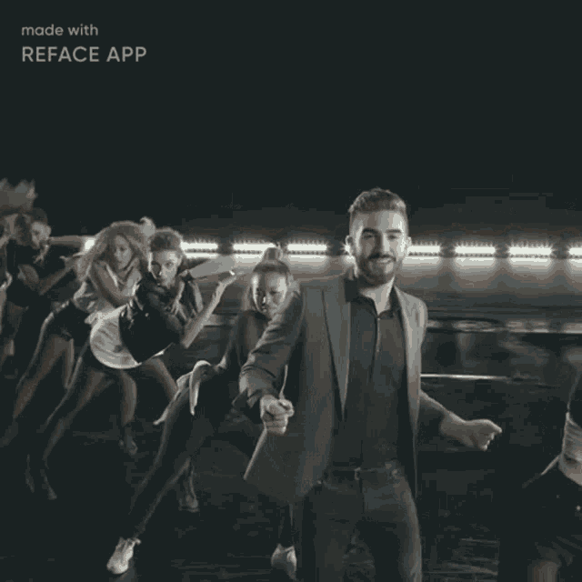 a man in a suit is dancing in front of a group of dancers with the words made with reface app below him