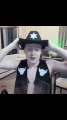 a man without a shirt is wearing a cowboy hat