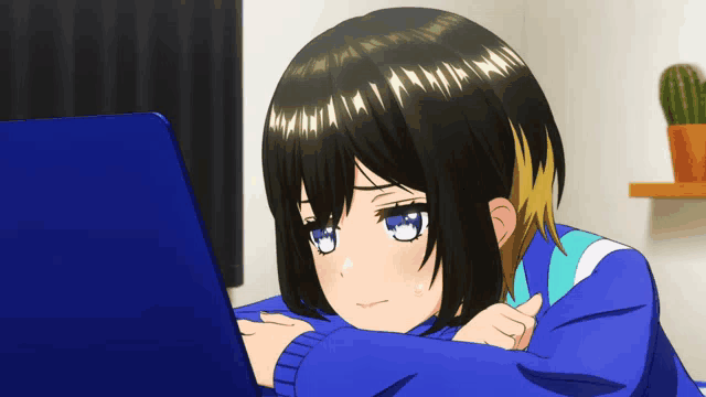 a girl with black hair and blue eyes looks at a laptop