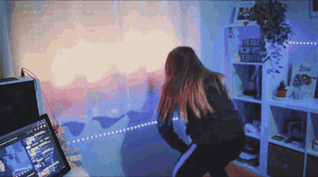 a woman is dancing in front of a zelda sign on a shelf