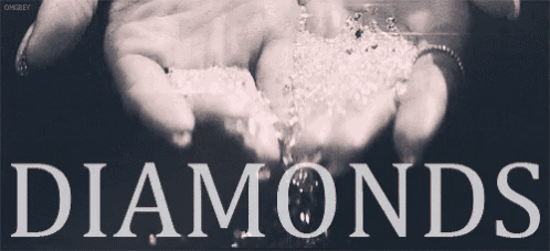 a person is holding diamonds in their hands
