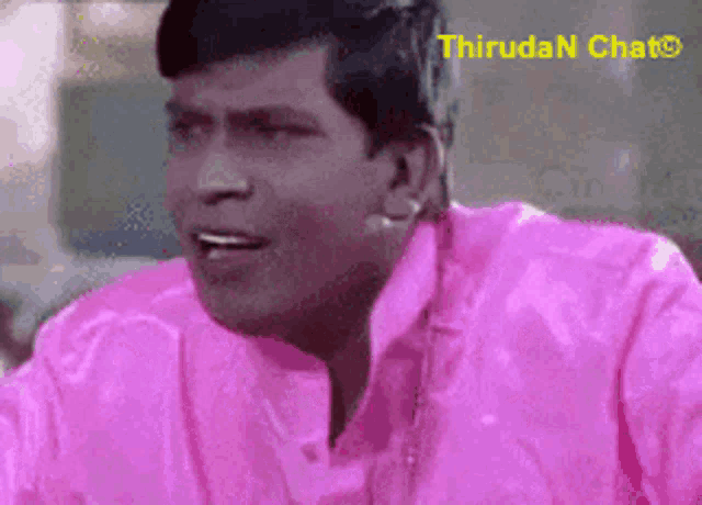 a man is wearing a pink shirt with thiruda n chat written on the bottom