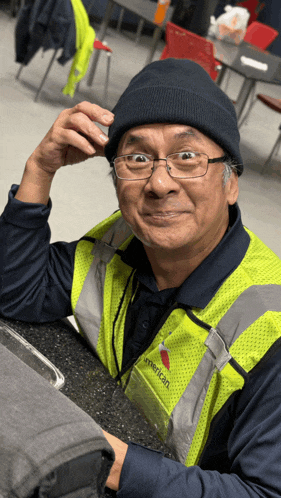 a man wearing a yellow vest that says " american "