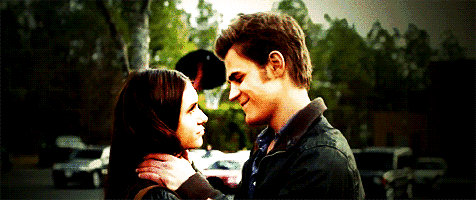 a man and a woman are looking at each other