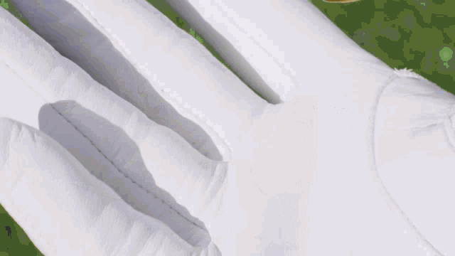 a close up of a person 's hand with a gold ring on it