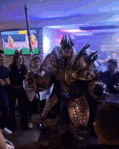 a group of people are gathered around a man in a costume that says always on it