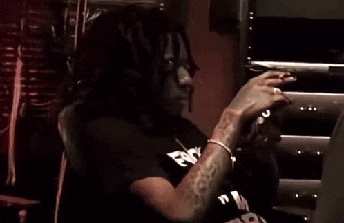 a man with dreadlocks is wearing a black shirt that says fox