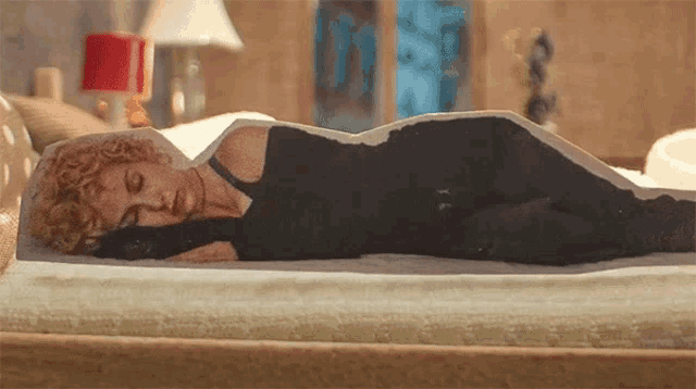 a drawing of a woman laying on a bed
