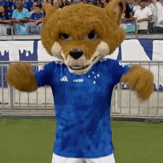 a mascot wearing a blue adidas shirt is dancing on a field