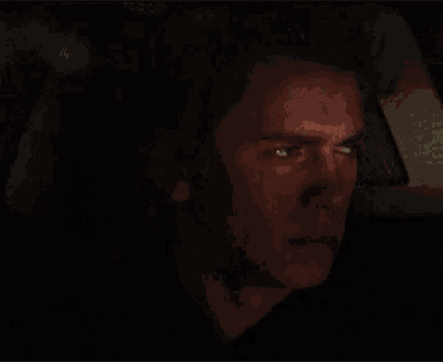 a close up of a man in a dark room
