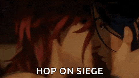 a man and a woman are kissing with the words `` hop on siege '' behind them .