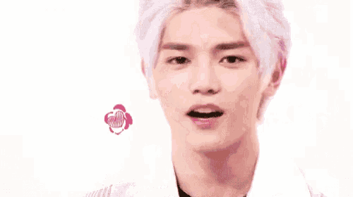 a close up of a person 's face with hearts flying around him .