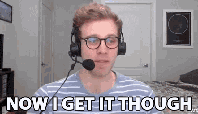 a man wearing headphones and a microphone says now i get it though