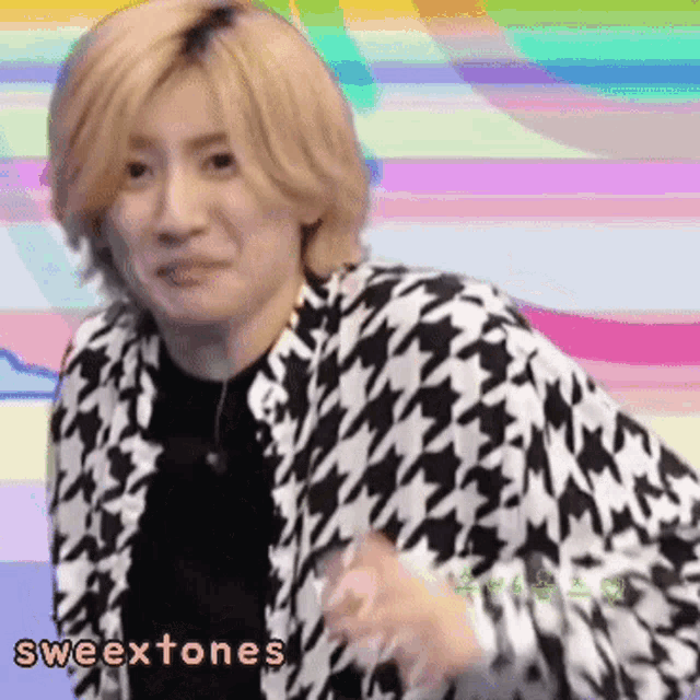 a man wearing a black and white houndstooth jacket with the words sweextones written on the bottom