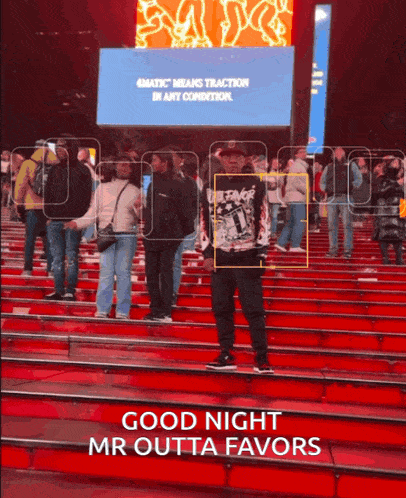 a man standing on a set of red stairs with the words good night mr outta favors above him