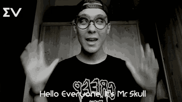 a young man wearing glasses and a hat says hello everyone mr. skull