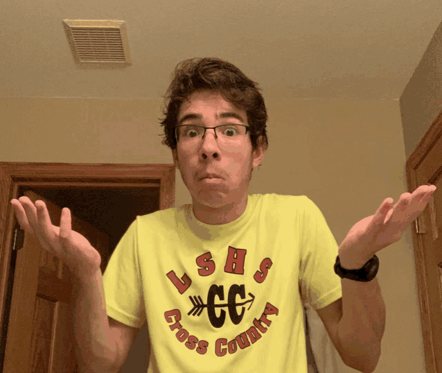 a young man wearing a yellow shirt that says ushs cross country