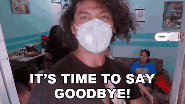 a man with curly hair wearing a mask says it 's time to say goodbye